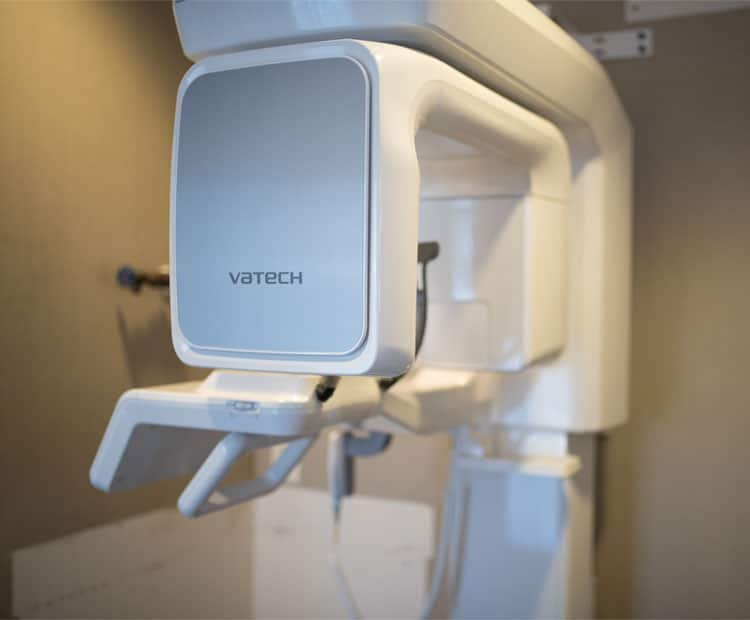 A white and silver Vatech dental 3D X-ray machine.